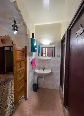 a bathroom with a sink and a mirror at Appartement Old Medina fes in Fès