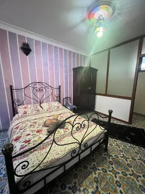 a bedroom with a bed and a rainbow wall at Appartement Old Medina fes in Fès