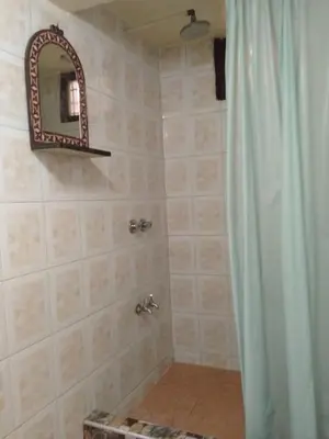 a bathroom with a shower with a mirror at Appartement Old Medina fes in Fès