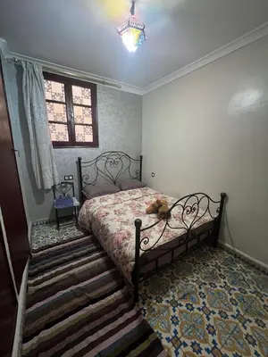 a bedroom with a bed with a teddy bear on it at Appartement Old Medina fes in Fès
