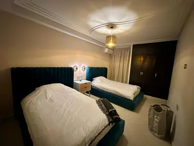 a hotel room with two beds in a room at Les Palmiers de l ile Jacob in Fès
