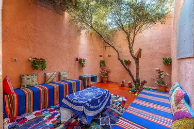 a living room with a couch and a table at Atlas Suite Riad 3 Bedrooms near Marrakech in Tikoutar