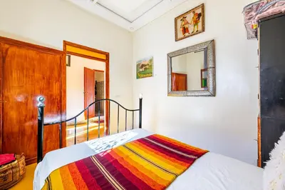 a bedroom with a bed and a mirror on the wall at Atlas Suite Riad 3 Bedrooms near Marrakech in Tikoutar