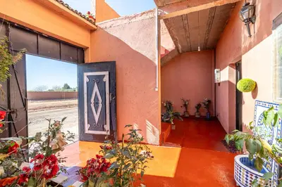a building with a door with a painting on it at Atlas Suite Riad 3 Bedrooms near Marrakech in Tikoutar
