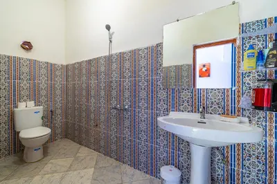 a bathroom with a sink and a toilet at Atlas Suite Riad 3 Bedrooms near Marrakech in Tikoutar