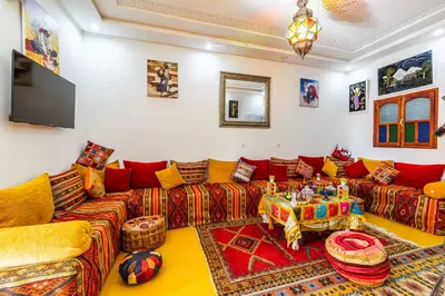 a living room with a couch and a table at Atlas Suite Riad 3 Bedrooms near Marrakech in Tikoutar