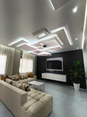 a living room with a couch and a tv on the ceiling at Appartment in hearth of new Fes in Fès