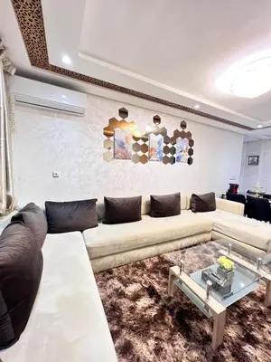 a living room with a couch and a table at Cozy apartment and central location in Meknès