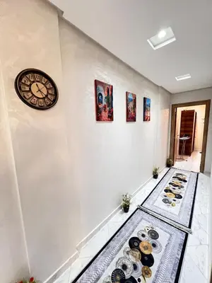 a room with a clock and plates on the floor at Cozy apartment and central location in Meknès