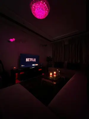 a living room with a tv in a dark room at Cozy apartment and central location in Meknès