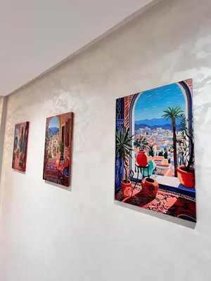 three pieces of art hanging on a wall at Cozy apartment and central location in Meknès