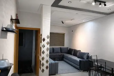 a living room with a couch and a table at Appartement propre in Fès