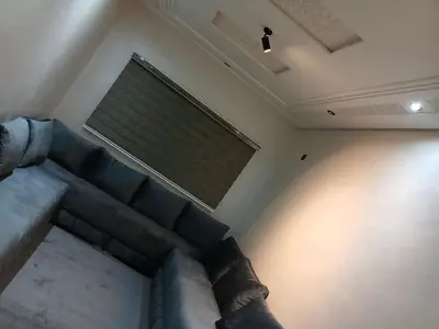 a living room with a couch and a window at Appartement propre in Fès