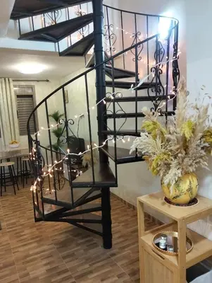 a black spiral staircase with lights in a room at High-Standing Accommodations - Dalia , Tiflet in Tiflet