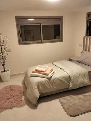 a bedroom with a bed with two towels on it at High-Standing Accommodations - Dalia , Tiflet in Tiflet