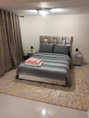 a bedroom with a large bed and a rug at High-Standing Accommodations - Dalia , Tiflet in Tiflet