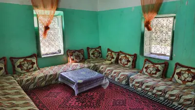 a living room with couches and a table in it at gite traditionnel berbère chez Naima in Lac Yasmins