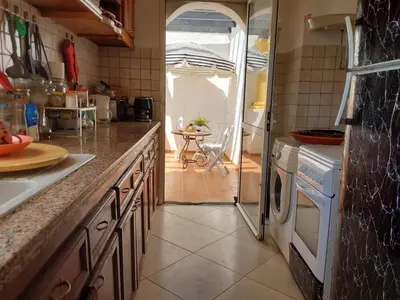 a kitchen with a sink and a stove top oven at Appartement front de mer à Sidi Rahal