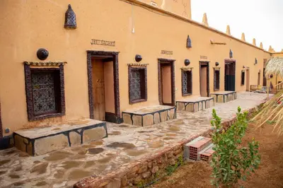 a building with a row of benches in a courtyard at Riad Du Sud in Tamsahelt