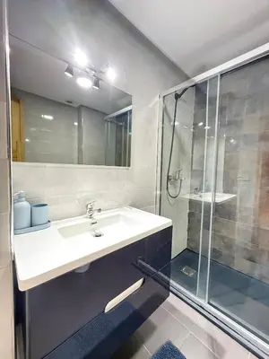 a bathroom with a sink and a shower at Luxury Modern Apartment City Center in Meknès