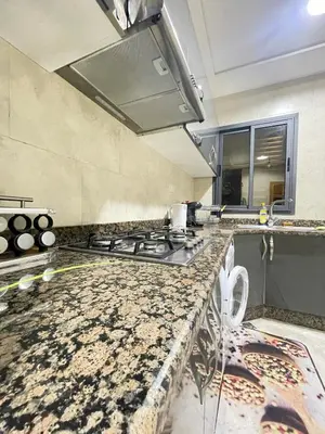 a kitchen with a stove and a counter top at large & comfotable apartment close to everything in Meknès