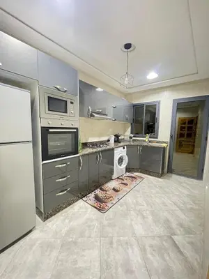 a kitchen with a sink and a stove top oven at large & comfotable apartment close to everything in Meknès