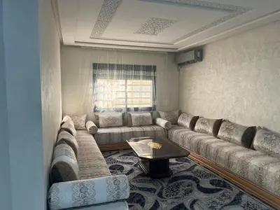 a living room with a large couch and a table at Luxury University Apartment 3 in Fès