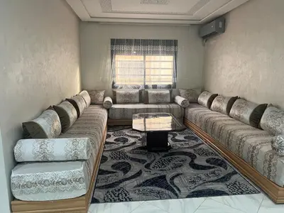 a living room with a large couch and a table at Luxury University Apartment 3 in Fès