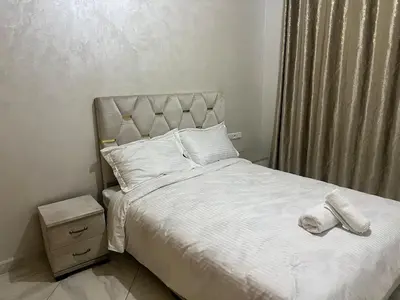 a bedroom with a bed with white sheets and pillows at Luxury University Apartment 3 in Fès