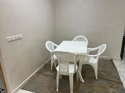 a white table and chairs in a room at Luxury University Apartment 3 in Fès