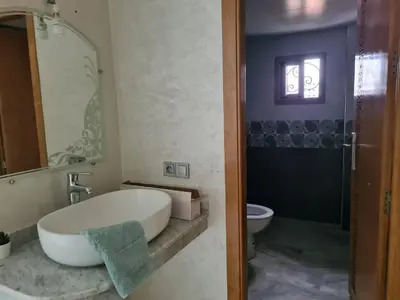 a bathroom with a tub and a sink and a toilet at apparemment in Fès