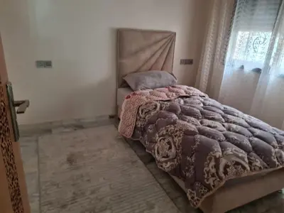 a bedroom with a bed and a window at apparemment in Fès