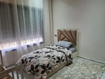 a bedroom with a bed and a window at apparemment in Fès