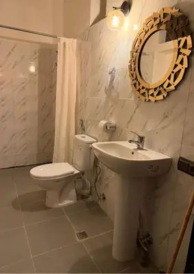 a bathroom with a toilet and a sink and a mirror at Atlas city fes in Fès