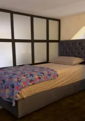 a bedroom with a large bed with a wooden headboard at Atlas city fes in Fès