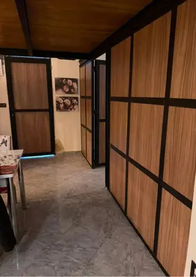 a hallway with wooden sliding doors in a room at Atlas city fes in Fès