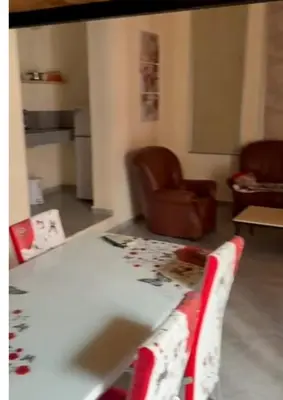 a living room with a table and a chair at Atlas city fes in Fès