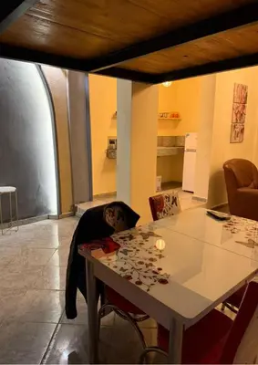 a dining room with a table and chairs and a room at Atlas city fes in Fès