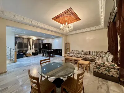a living room with a table and a couch at Villa Fez Prestige with jacuzzi, Chic & peaceful in Fès