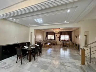 a large living room with a table and chairs at Villa Fez Prestige with jacuzzi, Chic & peaceful in Fès