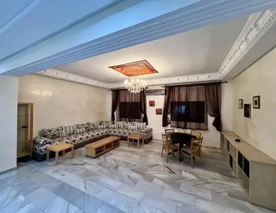 a living room with a couch and a table at Villa Fez Prestige with jacuzzi, Chic & peaceful in Fès