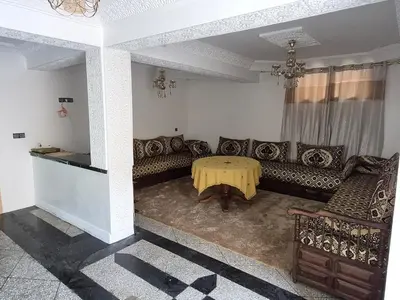 a living room with a couch and a table at Villa avec Piscine Meknes in Meknès