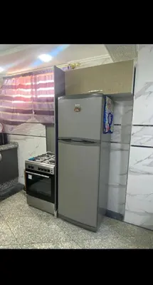 a kitchen with a refrigerator and a stove at Villa avec Piscine Meknes in Meknès