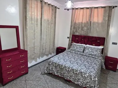 a bedroom with a bed and a mirror and a dresser at Villa avec Piscine Meknes in Meknès