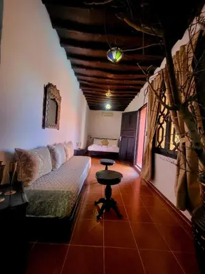 a living room with a couch and a table at Ferme des Oliviers - Villa de Charme avec Vue Nature in Sfiani