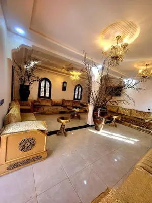 a lobby with a large room with a couch and tables at Ferme des Oliviers - Villa de Charme avec Vue Nature in Sfiani