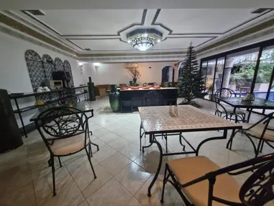 a dining room with tables and chairs and a christmas tree at Ferme des Oliviers - Villa de Charme avec Vue Nature in Sfiani