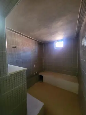 a bathroom with a tub and a window in it at Ferme des Oliviers - Villa de Charme avec Vue Nature in Sfiani