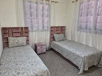 a bedroom with two beds and a window at Villa appartement jardin et piscine in Meknès
