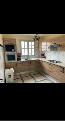 a kitchen with a sink and a stove top oven at Villa appartement jardin et piscine in Meknès
